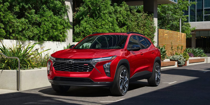A red 2026 Chevrolet Trax parked outside showcasing its sleek design and modern appeal.